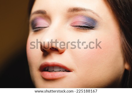 Cosmetic beauty procedures and makeover concept. Closeup part of woman face makeup detail. Eyes with color eyeshadows