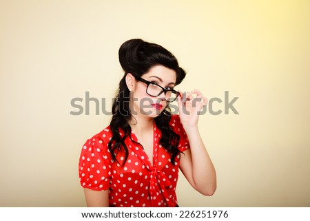 Retro. Portrait of stylish young woman student or teacher in eyeglasses on yellow. Brunette girl in pinup style. Education.