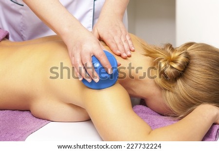 Beauty treatment concept. Woman getting spa therapy cupping glass vacuum massage in salon. Alternative medicine procedure, body care healthy lifestyle.