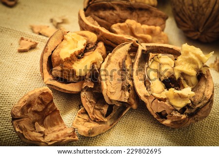 Healthy food full of omega-3 fatty acids, organic nutrition. Walnut kernels on burlap rustic old table