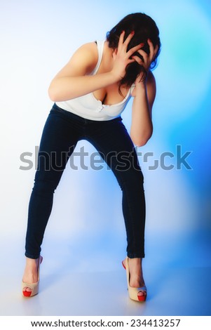 Stress negative emotions frustration. Young emotional woman angry frustrated and stressed pulling her hair. Studio shot