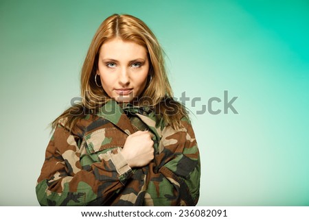 Beautiful sexy woman in military clothes fit army girl portrait on green