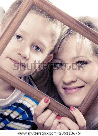 Happy family and love concept. Portrait of middle-aged mother with son little boy holding frame decorations studio shot isolated on white