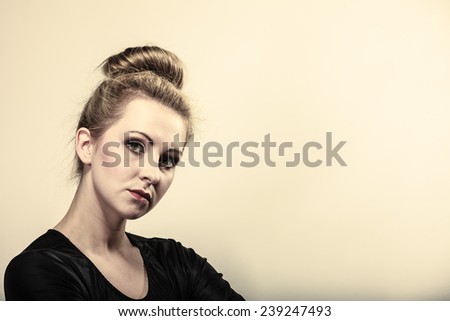Portrait of young beautiful girl blonde woman makeup and hair bun gray background