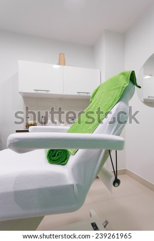 Chair in modern healthy beauty spa salon. Interior of treatment room. Luxury relax therapy.