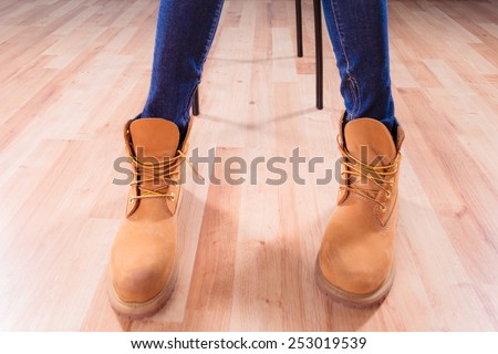 Legs in leather warm brown winter boots indoor