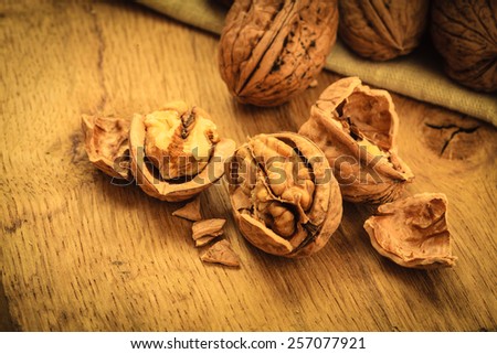 Healthy food full of omega-3 fatty acids, organic nutrition. Walnut kernels and whole on rustic old wooden table