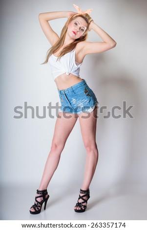 Full length pin up beautiful blonde fashion girl retro styling, studio shot gray background
