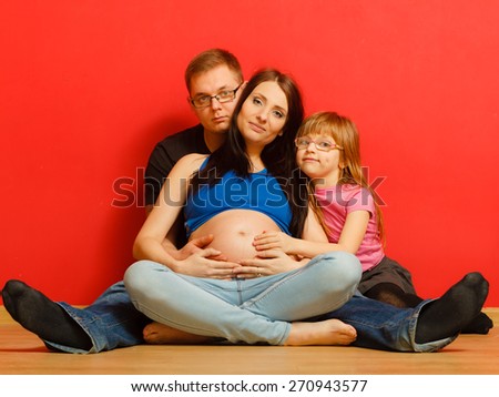 Pregnancy, parenthood and happiness concept. Family expecting new baby, portrait of three face at home
