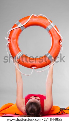 Accident prevention and water rescue. Woman holding life buoy ring lifebelt studio shot gray background