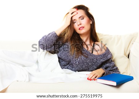 Health balance sleep deprivation concept. Woman lying on couch suffering from head pain taking power nap