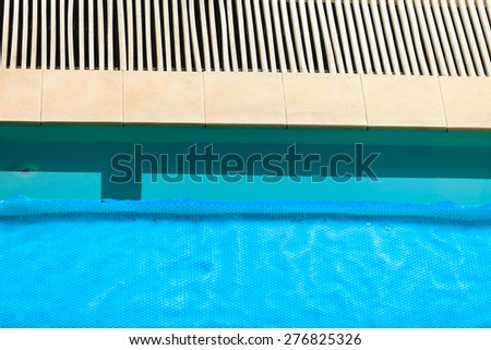 Relax active lifestyle or travel concept. Swimming pool at hotel close up, water covered with safety net grid