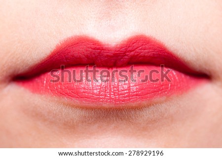 Cosmetic beauty procedures and makeover concept. Closeup part of woman face red lips makeup detail. Lipstick or lipgloss