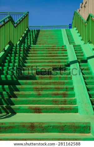 Green concrete stairs stairway with railing handrail on sunny day. Architecture. Urban scene.