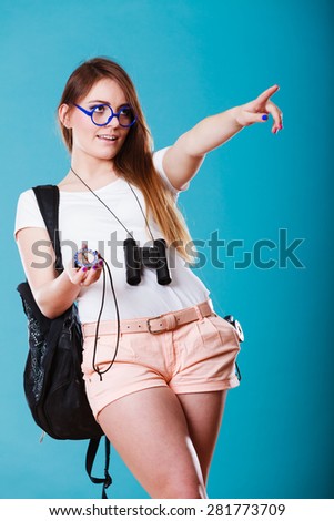 Summer vacation and tourism concept. Beauty woman long haired with backpack holding compass in hand on blue