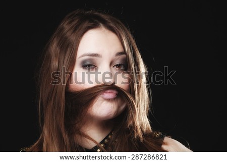 Sex equality and feminism concept - woman teen girl with hair moustaches making silly face on black