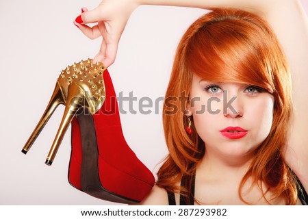 Fashion girl with red high heel shoes stiletto boots with gold studs. Women loves shoes concept
