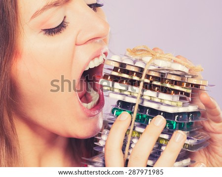 Woman taking pills. Girl female eating stack of tablets. Drug addict and health care concept. Overdose.