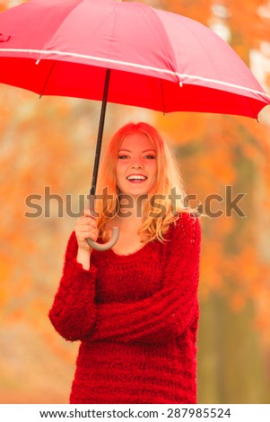 Happiness freedom and people concept. Casual young woman walking relaxing with red umbrella in autumnal park, outdoor