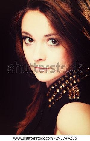 Young people teenage concept - pensive serious woman portrait, fashion teenager girl wearing blouse with gold metal stud on black