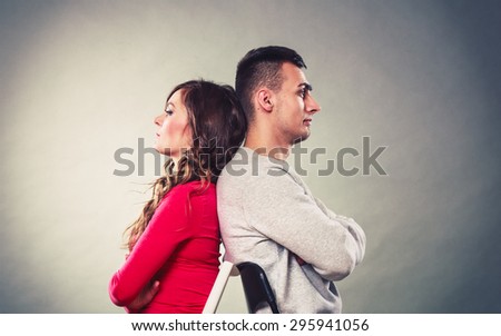 Bad relationship concept. Man and woman in disagreement. Young couple after quarrel sitting on chairs back to back