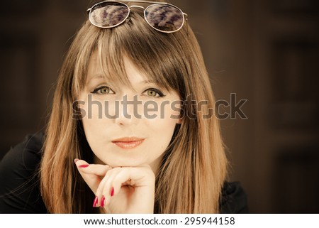 Portrait of young woman outdoors. Stylish fashionable girl in sunglasses relaxing on street