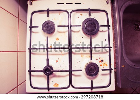 Housework, hygiene and cleaning concept. Dirt at home. Dirty filthy gas stove in kitchen