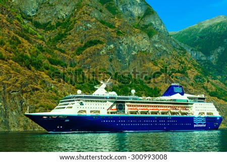 SOGNEFJORD GUDVANGEN-FLAM, NORWAY - JULY 23, 2014: Mountains and cruise ship on fjord Sognefjord on July 23, 2014, Norway, Scandinavia.