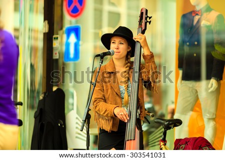 BERGEN, NORWAY - JULY 25, 2014: Gee Gee Kettel and Soluna Samay play on street during The Tall Ships Races in city Bergen on July 25, 2014, Norway. One Man Band, he also plays with his daughter Soluna