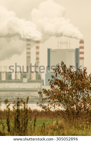 Energy. Smoke from chimney of power plant or station. Industrial landscape. Autumnal foggy day