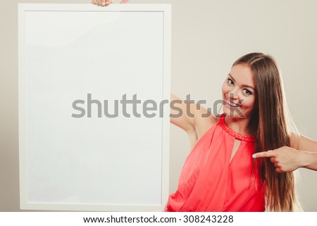 Cute attractive young woman girl in red shirt in studio with blank empty white copy space banner. Summer female fashion vogue and advertisement.