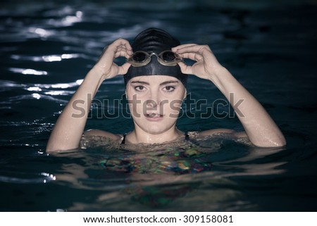 Woman athlete in swimming pool water. Water sport comptetition exercise. Human swimmer training.