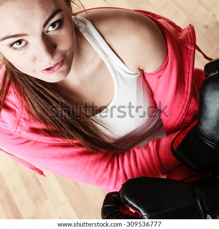 Emancipation and feminist. Defense concept. Young fit woman boxing. Indoor.