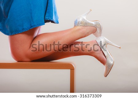 Closeup of sexy slim dancing woman legs wearing high heels and skirt. Pin up fashion.