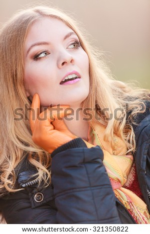 Portrait of pretty attractive fashionable woman in fall forest park. Gorgeous blonde young girl in jacket. Autumn winter fashion.