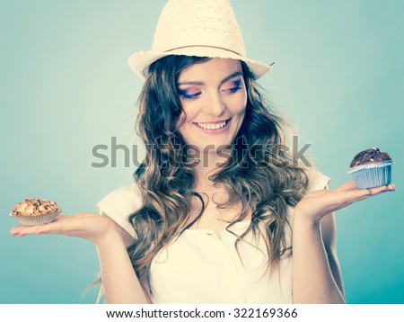 Bakery, sweet food and people concept. Closeup smiling summer woman curly hair straw hat holding cakes cupcakes in hands instagram filter