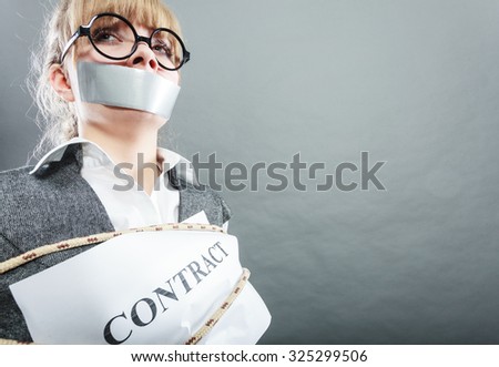 Afraid businesswoman bound by contract terms and conditions with mouth taped shut. Scared woman tied to chair become slave. Business and law concept.