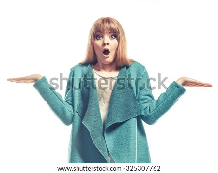 Fashion and advertisement concept. woman green blue coat holding open palms empty hands showing copy space surprised face expression isolated