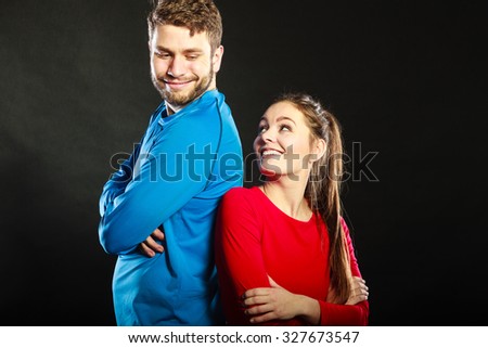 Portrait of smiling woman and man posing in studio on black. Happy joyful couple. Good relationship.