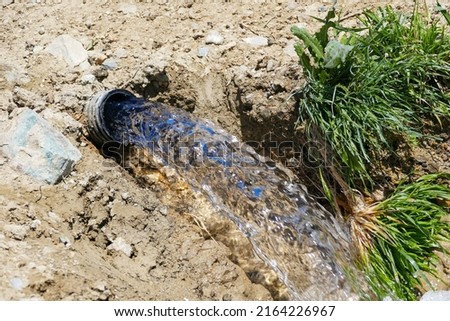 Similar – Image, Stock Photo Water flows through the potato plantation. Watering and care of the crop. Surface irrigation of crops. European farming. Agriculture. Agronomy. Providing farms and agro-industry with water resources.