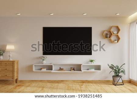 TV in the living room on a white wall by the window, decorated with plants, vases, flowers, toys and lamps.3d rendering