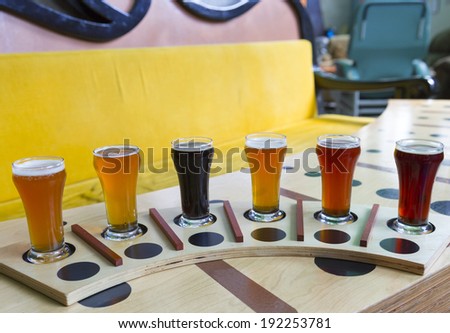 beer flight of six sampling mugs of light and dark craft beer