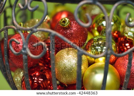 Round red and gold Christmas ornaments piled up in a vase