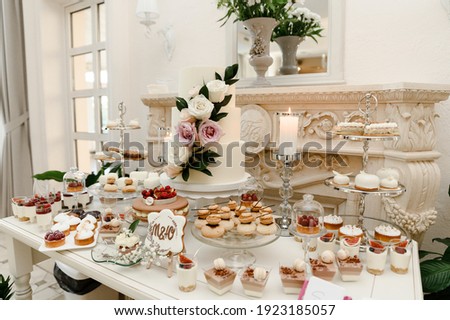 Similar – Image, Stock Photo Wedding candy bar table. Cakes with cream and berries and other sweets. High quality photo