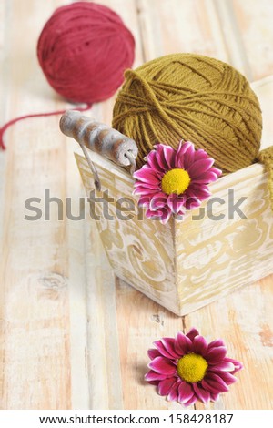 Wool clews for knitting with little burgundy flowers