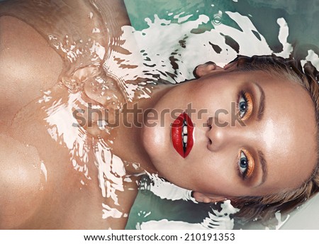 portrait of a beautiful glamourous blonde in water, spa concept, close up vogue portrait