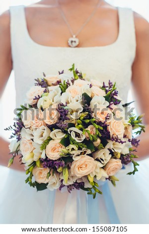Wedding bouquet of roses held by a bride