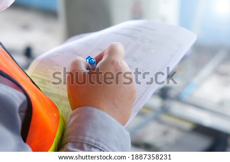 engineer write maintenance inspection check list ,record data for preventive maintenance,hand write data on check sheet. Stok fotoğraf © 