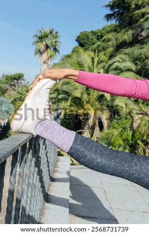 Similar – Image, Stock Photo Sportswoman stretching legs on stadium