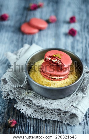 Makarons of chickpeas with pistachio cream on wooden background